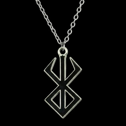 Silver pendant necklace on a dark background