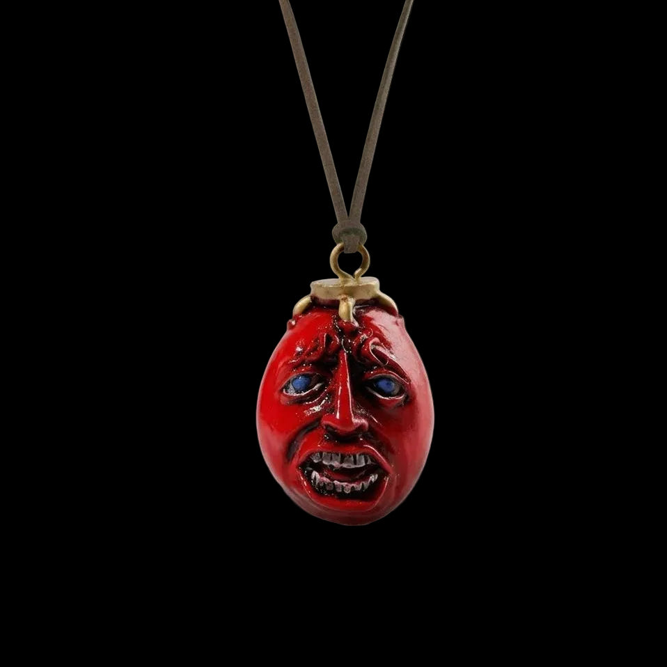 Red face pendant on a black background
