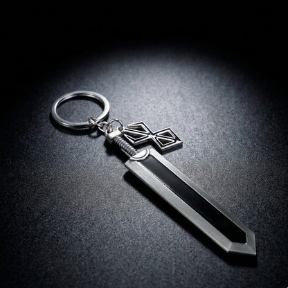 Metallic sword-shaped keychain on a dark surface