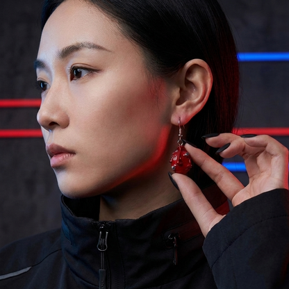 Person wearing a black jacket with a red light effect on a dark background