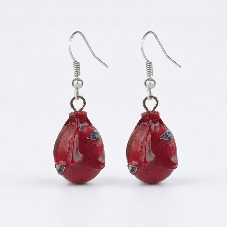 Red fish-shaped earrings on a white background