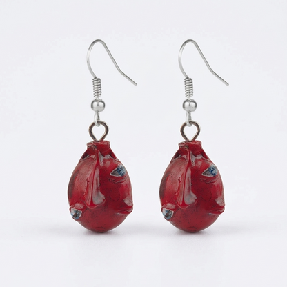 Red fish-shaped earrings on a white background