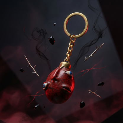 Red keychain with gold chain on a dark background
