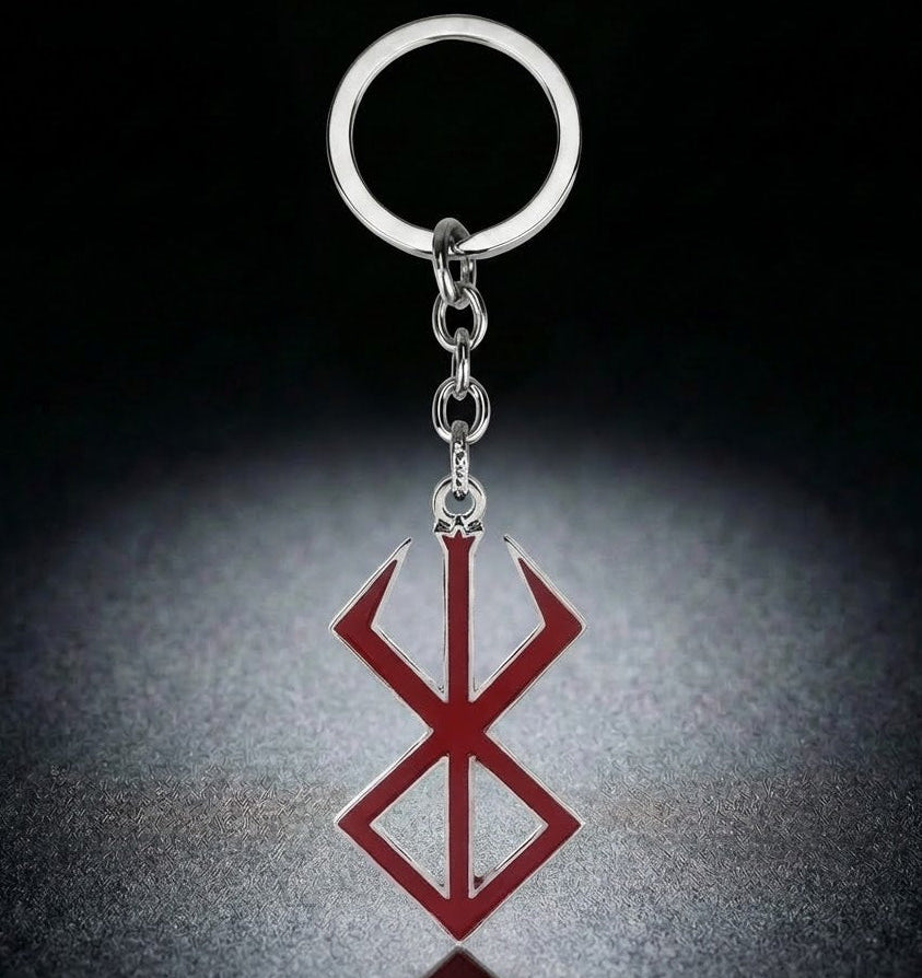 Keychain with a red and silver symbol on a dark background