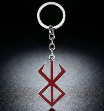 Keychain with a red and silver symbol on a dark background