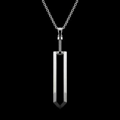 Black pendant on a silver chain against a black background