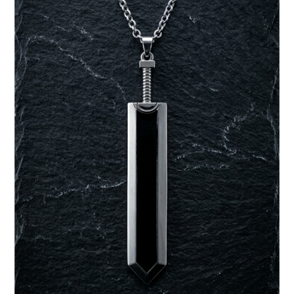 Black pendant on a silver chain against a dark stone background